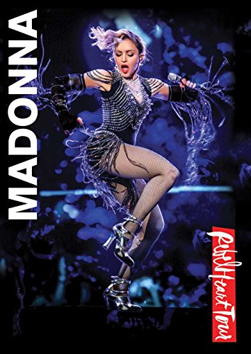 Madonna performing on stage in a sparkly outfit against a dark blue background.