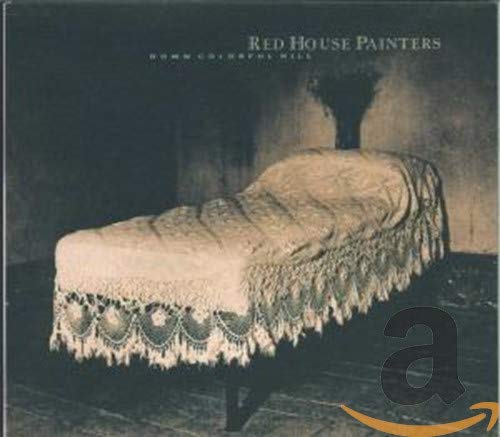 CD cover: dark room with a draped sofa and large letter "a".