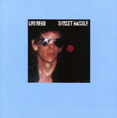 Lou Reed album cover: a man in sunglasses with a red dot.