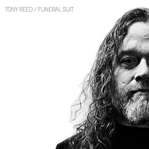 Black and white portrait of Tony Reed with long hair and beard.