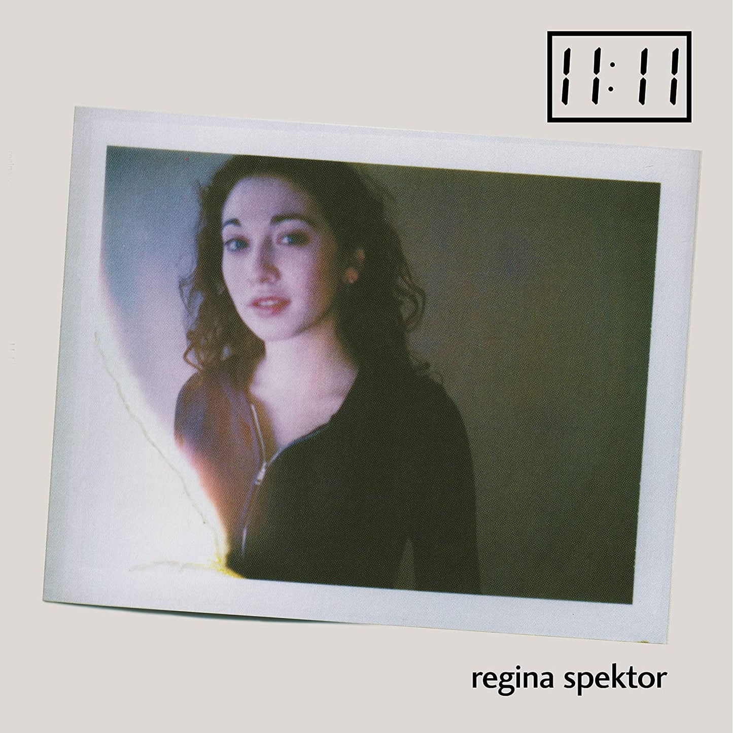 Regina Spektor album cover, portrait with "11:11" time display above.