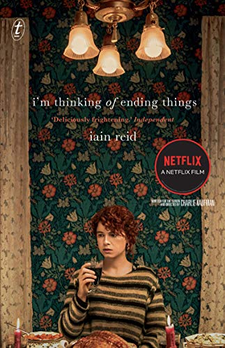 Book cover featuring a person holding a glass before floral wallpaper and lit lamps.