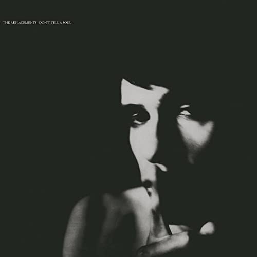 Black and white album cover featuring a shadowed face looking upward.