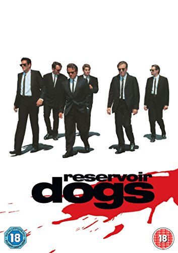 Six men in black suits walk toward the viewer, red splatter below.