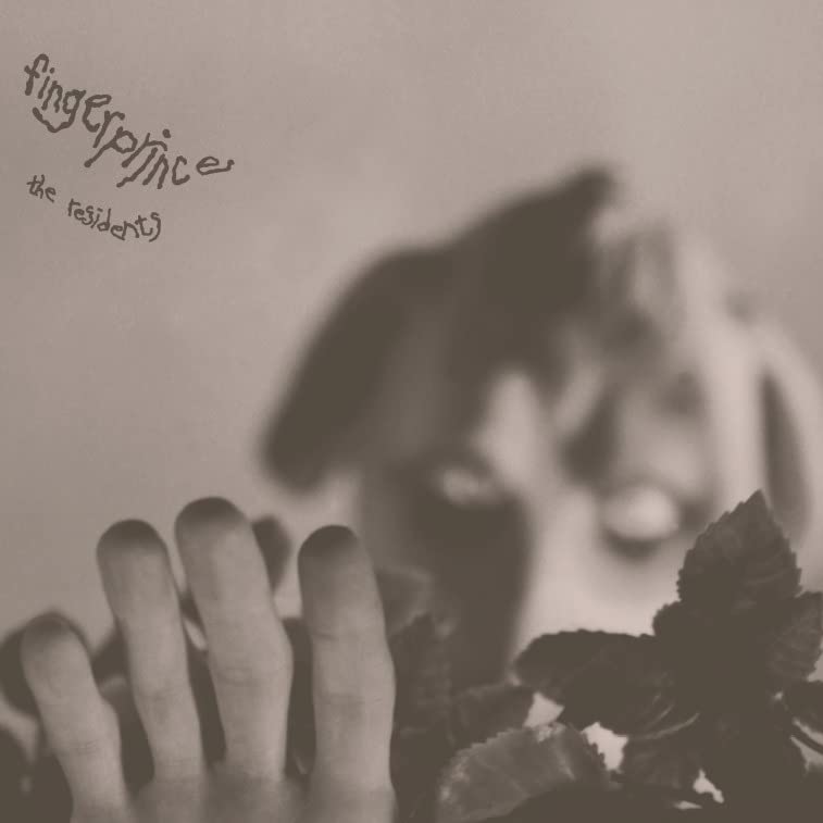 Sepia-toned vinyl record cover with blurred hand and foliage imagery.