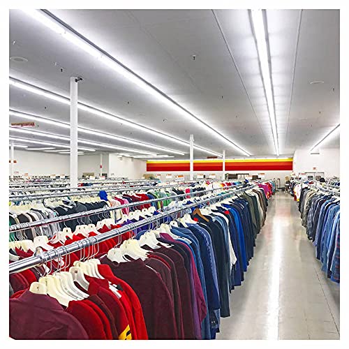 CD case displayed amongst rows of clothing in a retail store.
