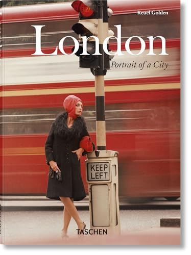 A woman in a red headscarf stands by a traffic light before a bus.