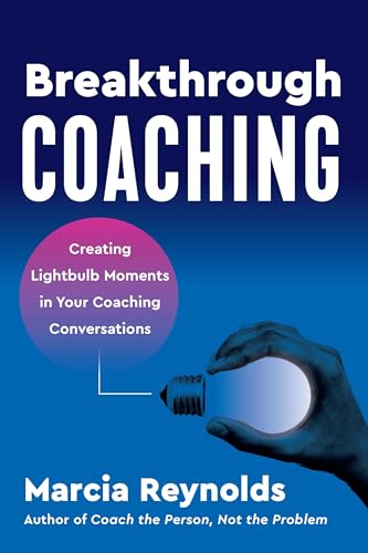 Book cover titled Breakthrough Coaching featuring a hand holding a glowing lightbulb.