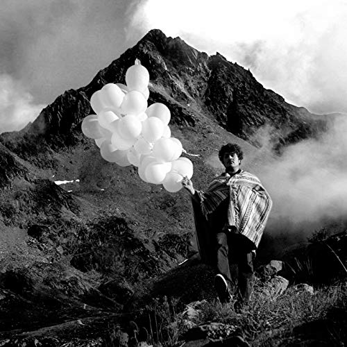 Black and white album cover featuring a man holding balloons near a mountain.