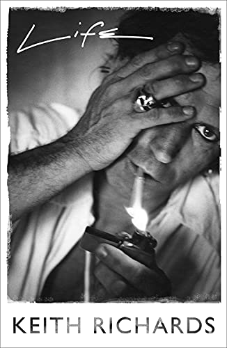 Black and white portrait of Keith Richards lighting a cigarette.