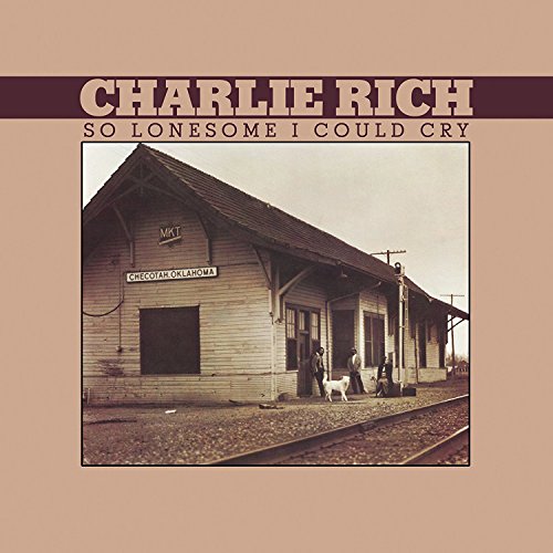 "Album cover with sepia-toned train station image and artist name, 'Charlie Rich'."