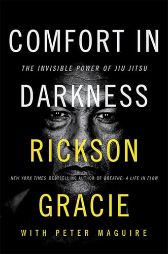 Book cover: "Comfort in Darkness" by Rickson Gracie, featuring a close-up portrait.
