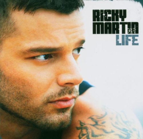 Close-up of Ricky Martin with short hair and tattoo on his shoulder.