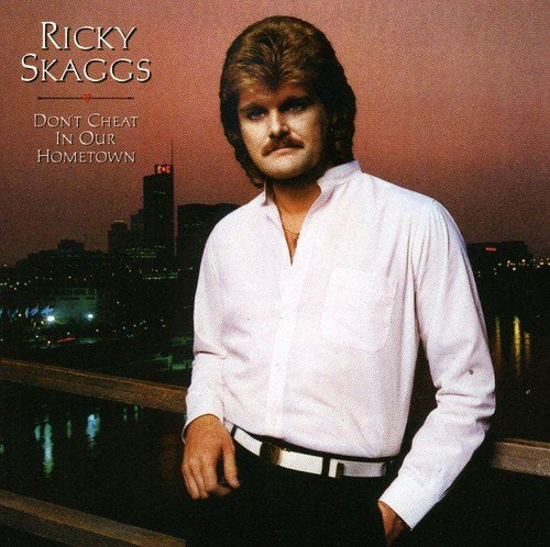 "CD cover of Ricky Skaggs' album featuring the artist standing against a cityscape."