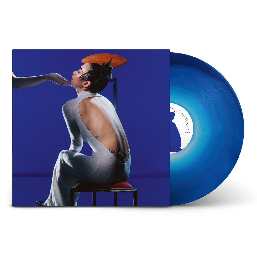 "Blue vinyl record with cover art featuring a woman sitting on a chair."