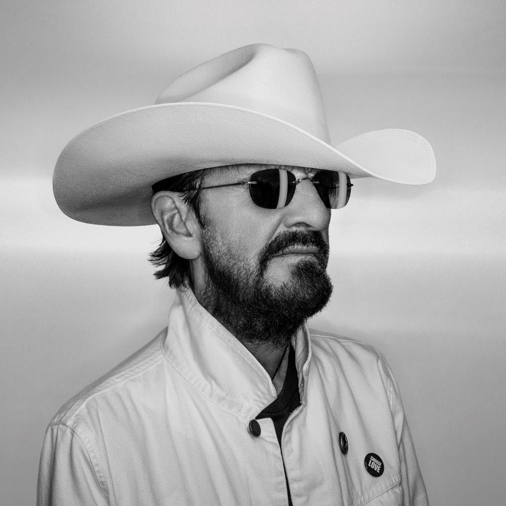 Black and white portrait of Ringo Starr wearing a cowboy hat and sunglasses.