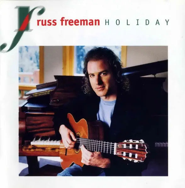 Russ Freeman playing guitar at a piano, album cover for "Holiday".