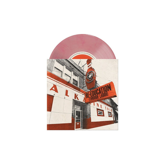 Pink vinyl record with album art depicting a building and red text.