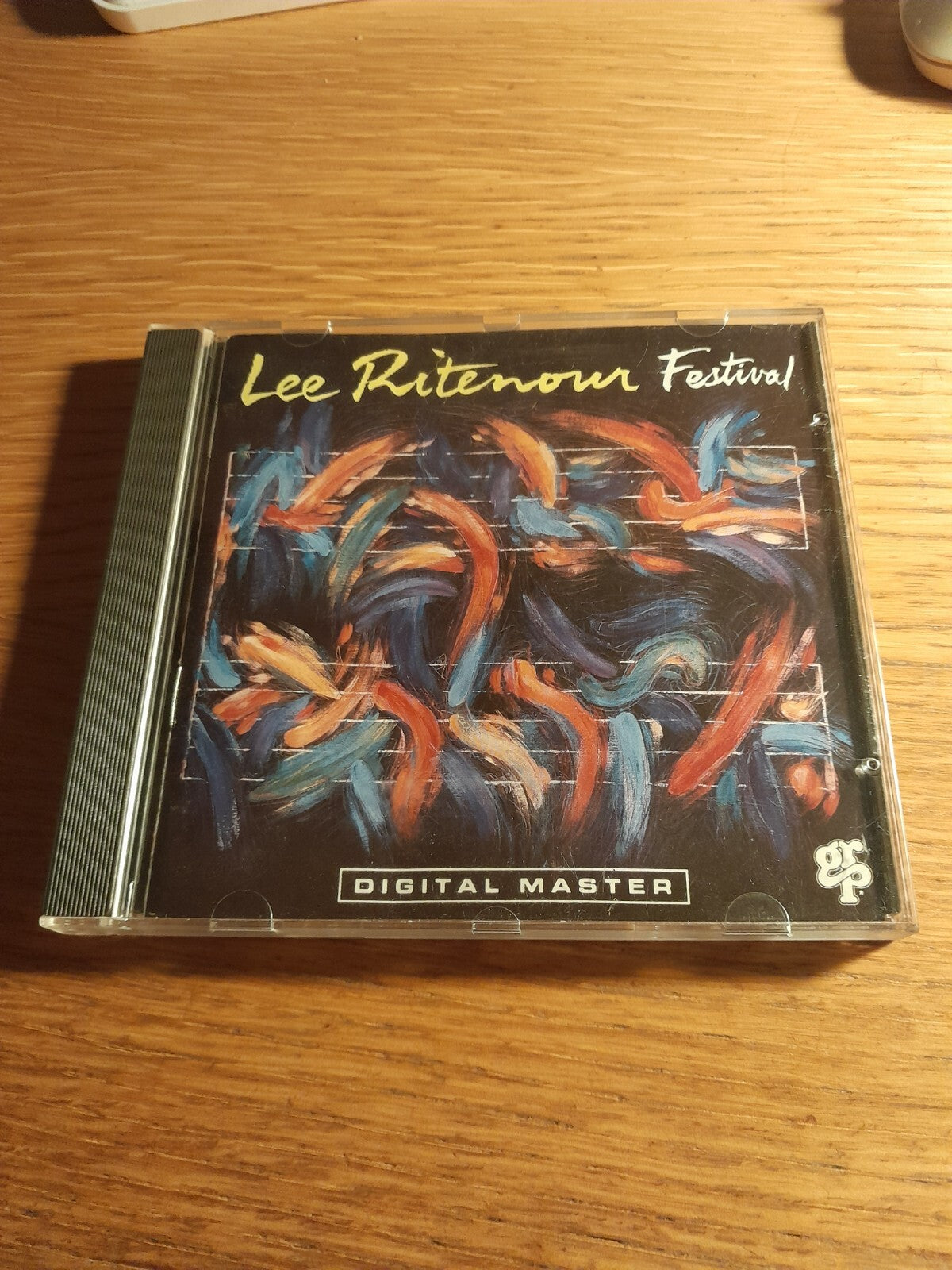 CD case for Lee Ritenour's "Portrait" album with abstract painted cover.