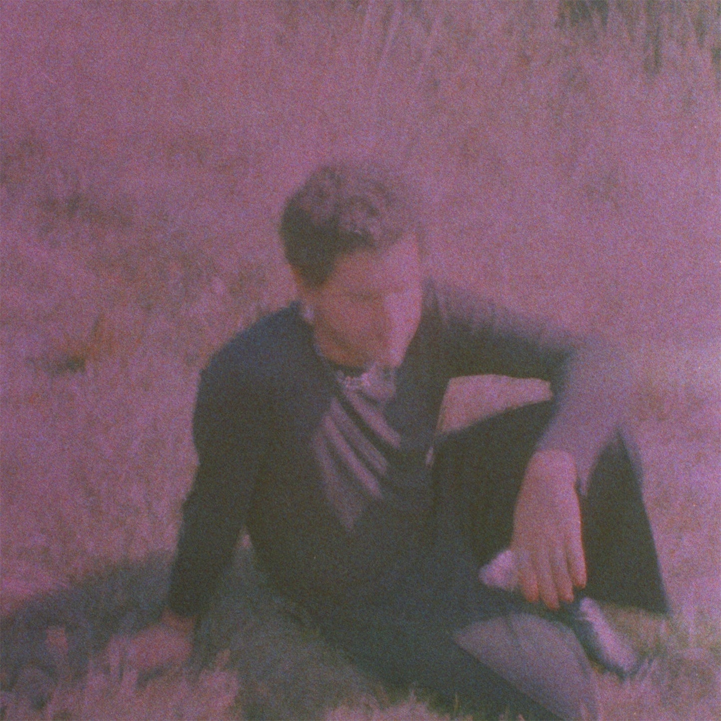 Purple-toned album cover featuring a person lying in grass.