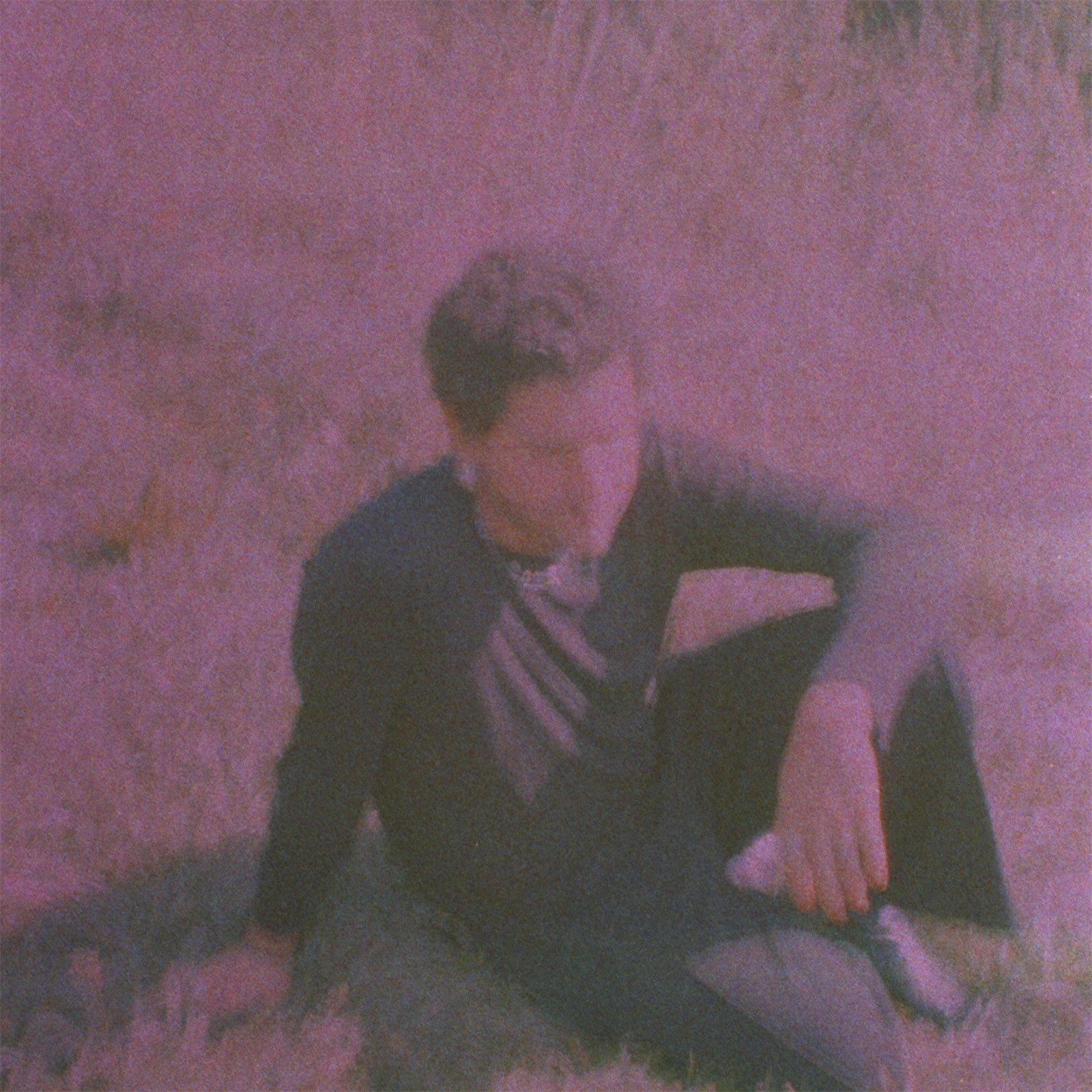 Purple-toned album cover featuring a person lying in grass.