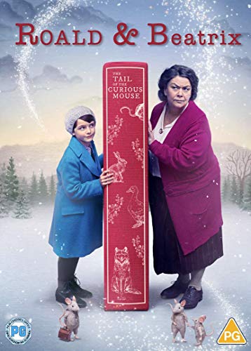 A boy and woman stand beside a large red book in a snowy landscape.