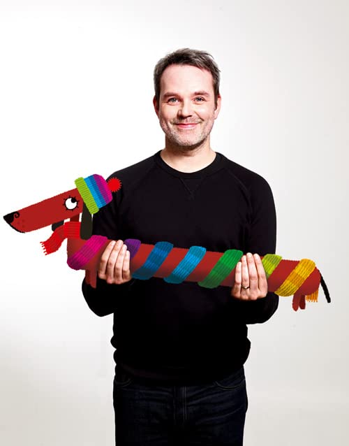 Man holding a long, colorful knitted dog illustration.