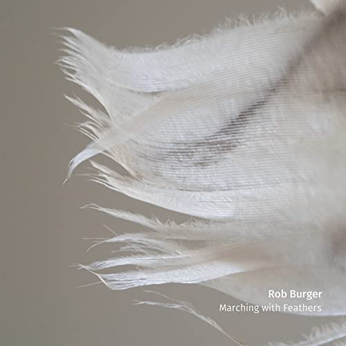 Close-up of white feathers with album title "Marching With Feathers.