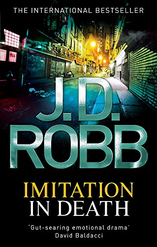 Book cover: “Imitation In Death” by J.D. Robb, dark city street scene.