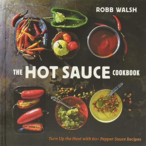 Cookbook cover featuring colorful chili peppers and bowls of sauce.