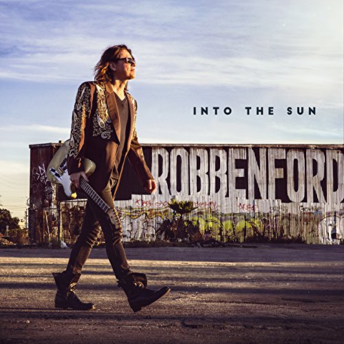 "Album cover: man walking with guitar, 'Robben Ford' on a building behind him."