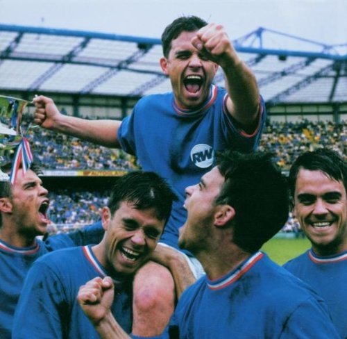 Robbie Williams on shoulders, celebrating with teammates at a stadium.