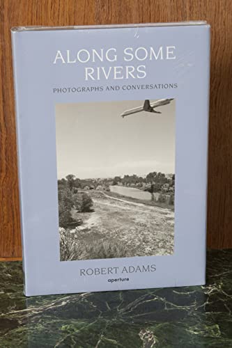 Book cover: "Along Some Rivers" with a river landscape and airplane.