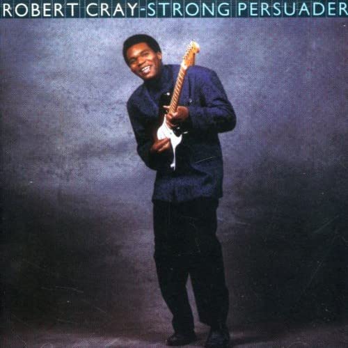 Robert Cray album cover: musician with guitar, dark background.