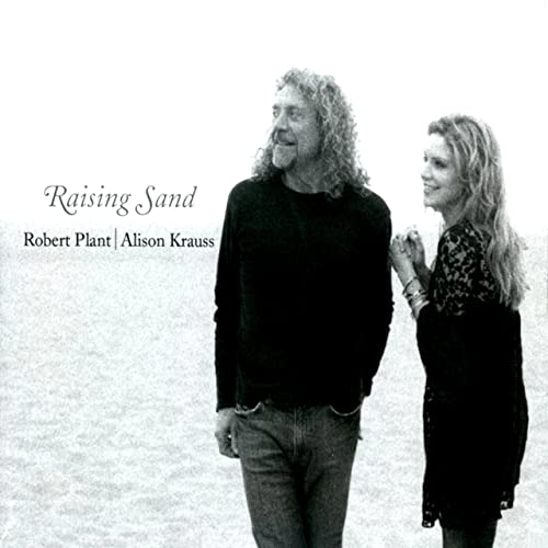 Black and white album cover featuring Robert Plant and Alison Krauss on a beach.