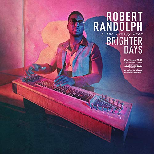 Vinyl record sleeve with a man playing a keyboard, partially revealing the black vinyl.