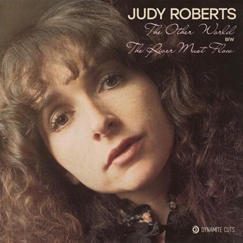 Close-up portrait of Judy Roberts with curly brown hair, album cover.