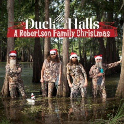Four bearded men in camouflage wear Santa hats in a swamp.