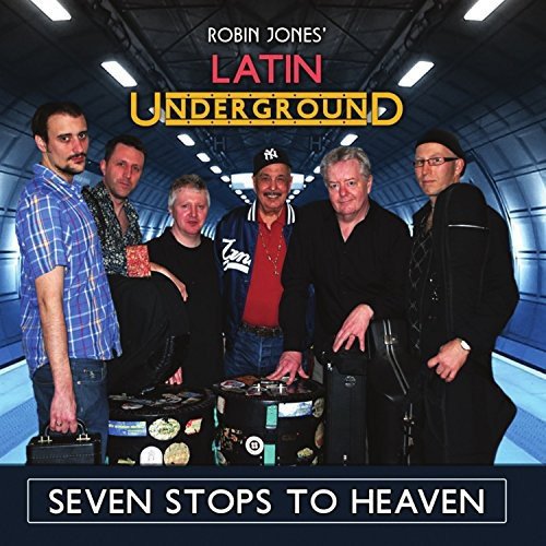 Six men posing with instruments in a subway tunnel, album cover.