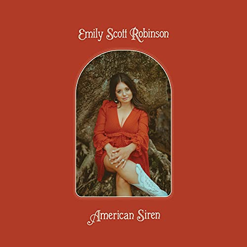 Emily Scott Robinson in a red dress sits in an archway against a tree.