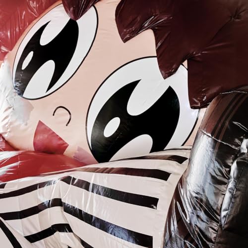 Close-up of an inflatable character with large eyes, dark hair, and striped clothing.