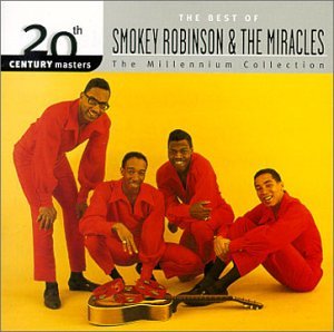 Smokey Robinson & The Miracles in red jumpsuits with a guitar.