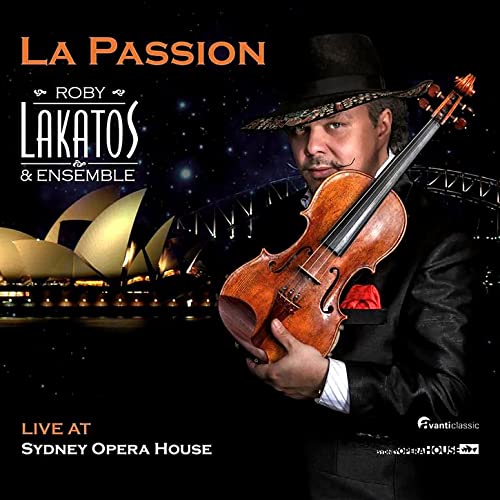 Roby Lakatos holds a violin, Sydney Opera House in the background.