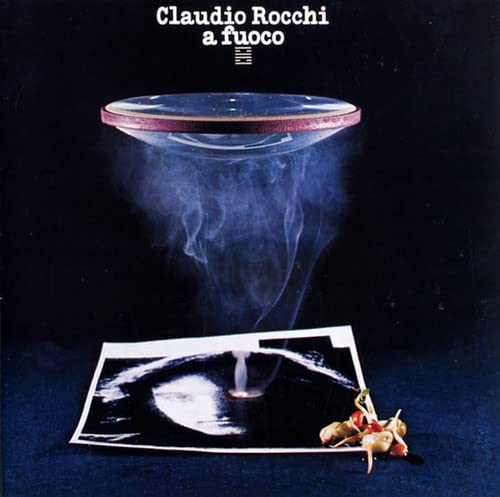 CD cover: dark background with a floating saucer and photograph.