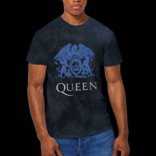A person wearing a black tie-dye t-shirt featuring a blue Queen band crest logo.