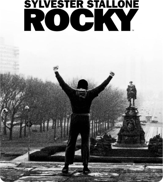 Black and white image of Sylvester Stallone as Rocky with arms raised.