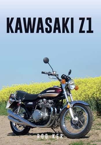 Vintage Kawasaki Z1 motorcycle parked in a field with yellow flowers.
