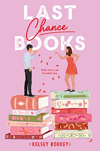 Book cover with illustrated couple standing on stacked books.