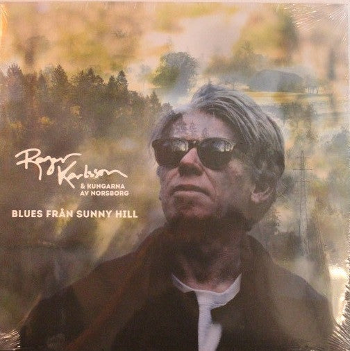 Vinyl album cover featuring a portrait of a man in sunglasses.