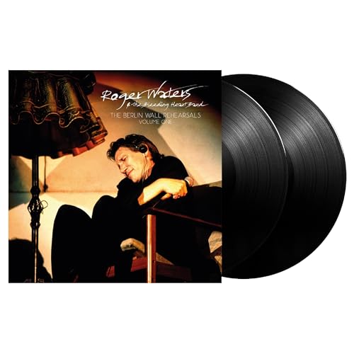 Black vinyl record with Roger Waters or band photo on sleeve, possibly Berlin Wall imagery.